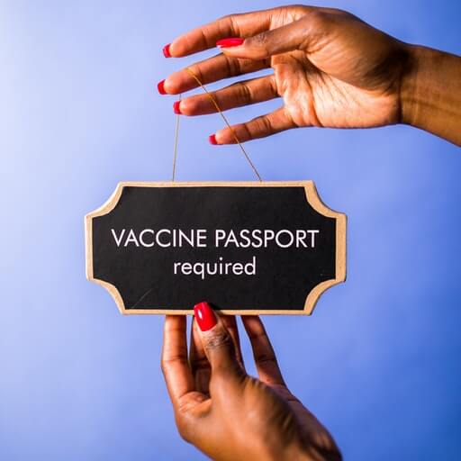 Vaccine Passport Required Sign held in hands